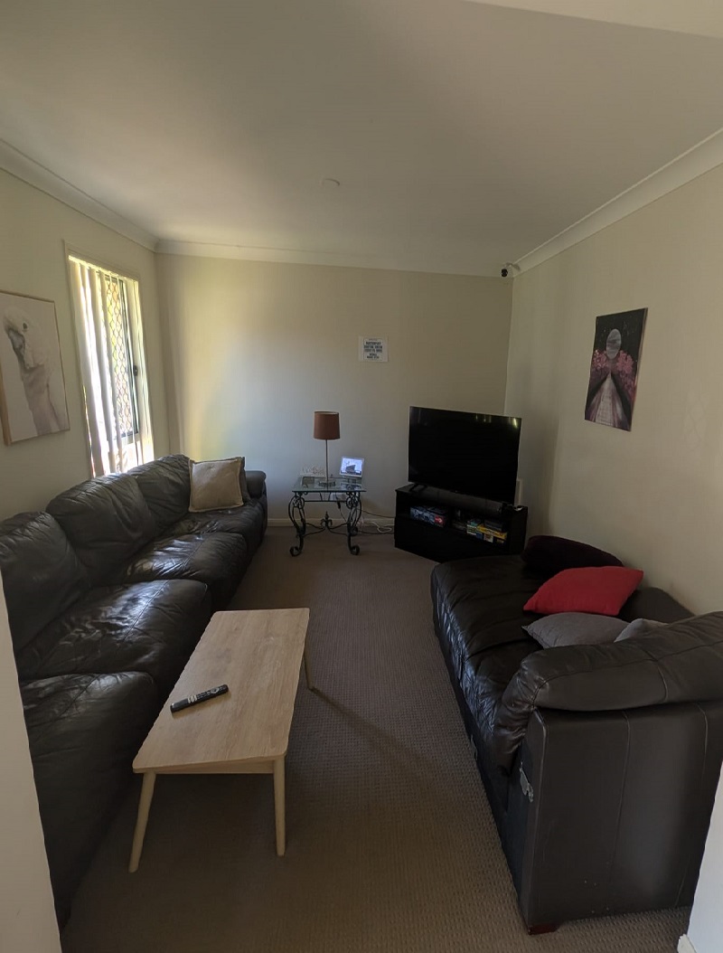 The lounge room of a Birch Care Supported Independent Living home, with sofas and a television